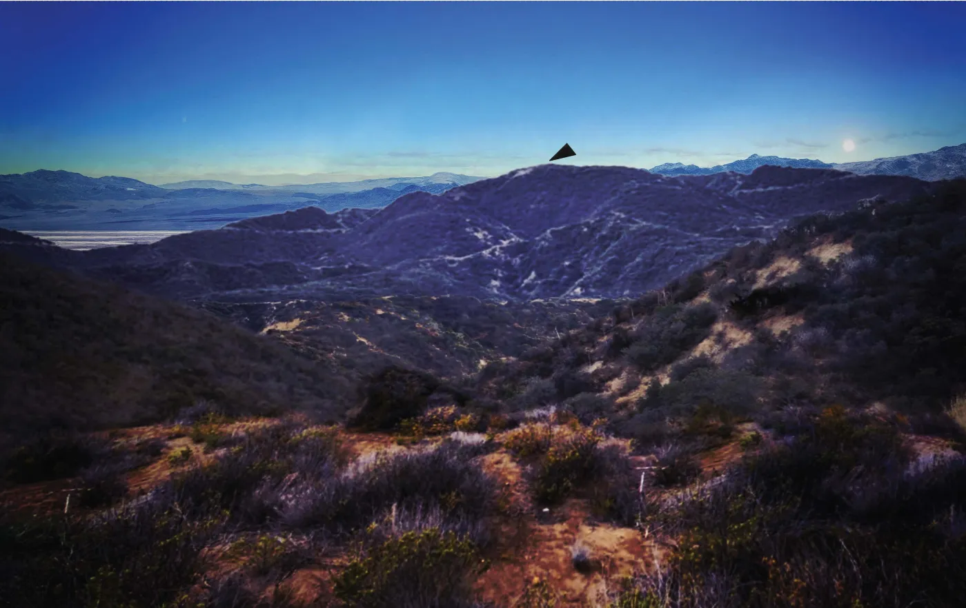 Rendition of the black triangle reported by federal agents over a mountain ridgeline, from the FBI file released in PURSUE Release 07. Frame 2: the black triangle appears above the ridgeline